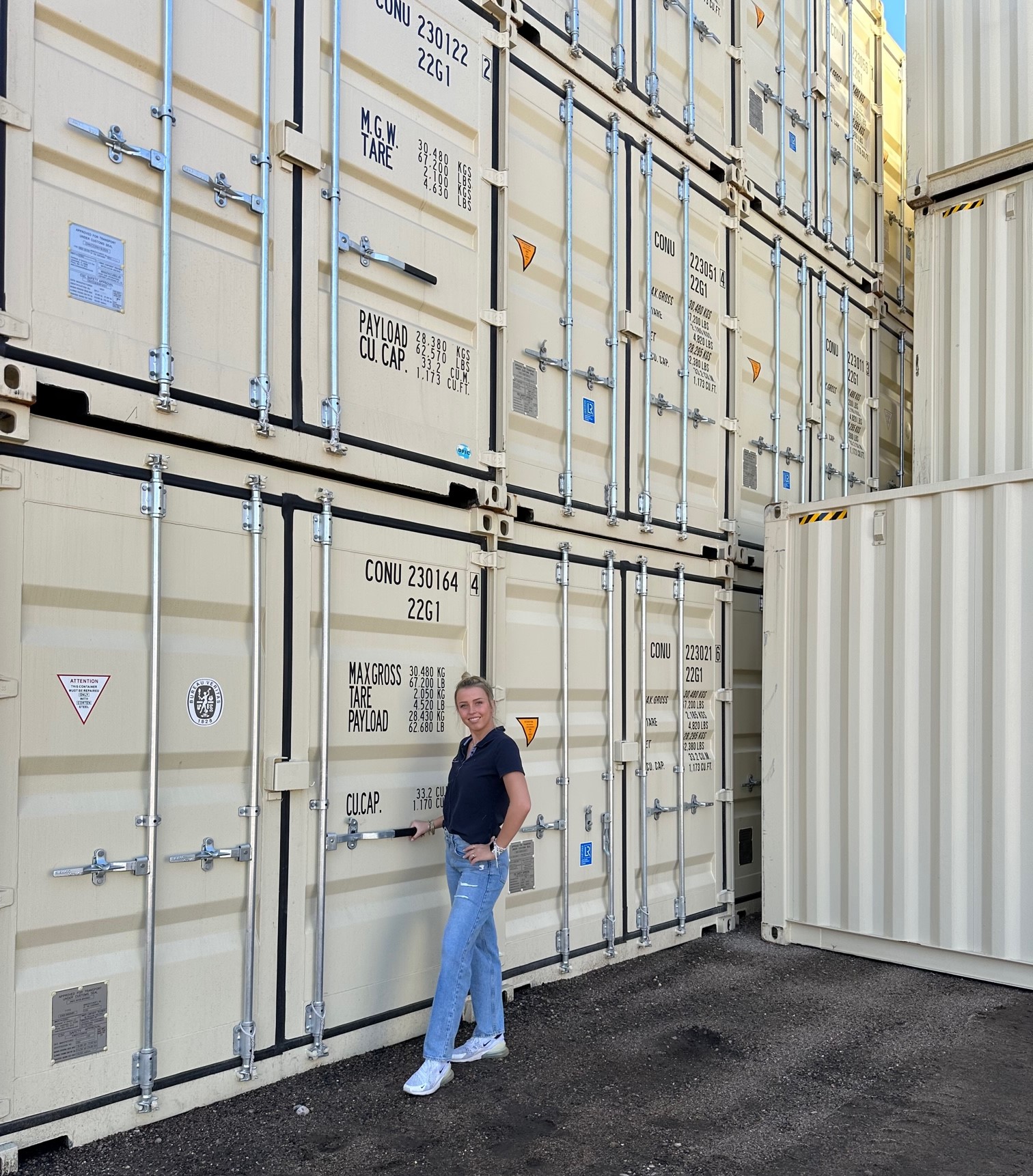 Woman Standing Beside Big Containers Woman Standing Beside Big Containers